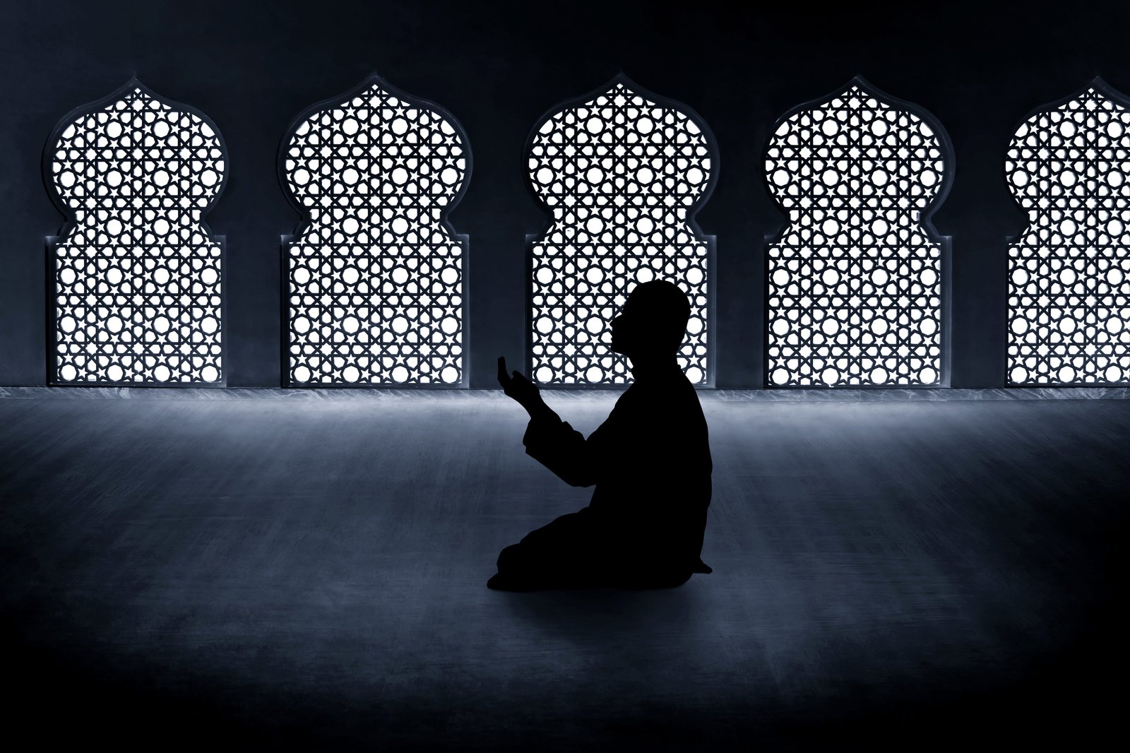 Silhouette of muslim man praying